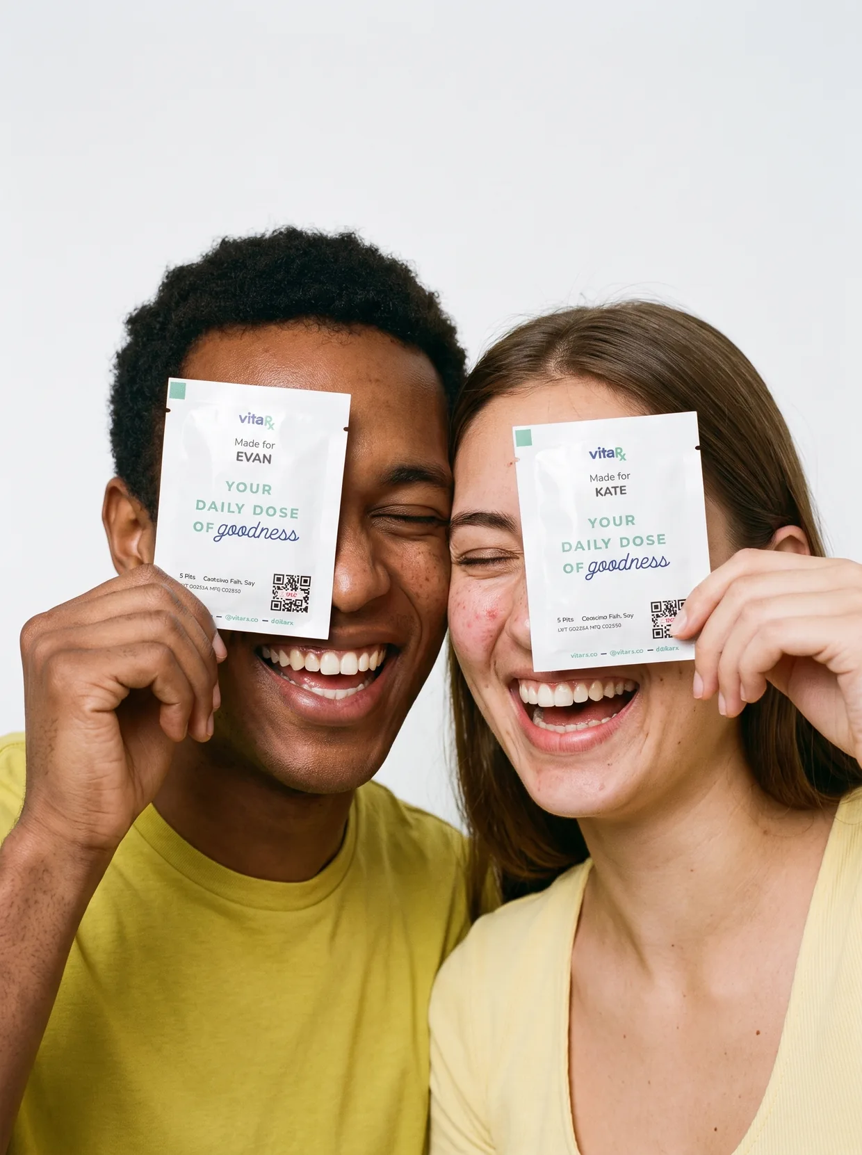 Two people holding personalized VitaRx daily packs